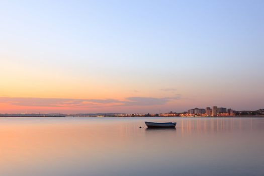 Boat on the tejo river and the city on background.