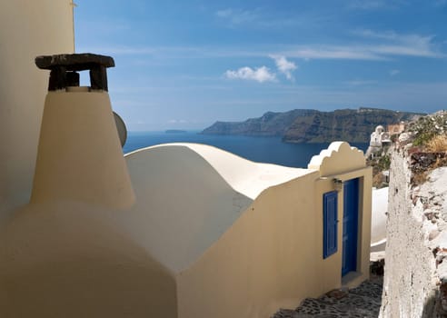 House with chimney of sienna color in Santorini Ia village