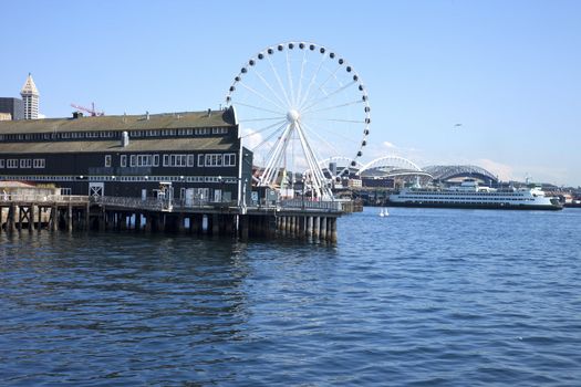 Seattle aquarium, ferries wheel and ferry near the waterfront.