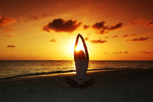 sunset yoga woman on sea coast