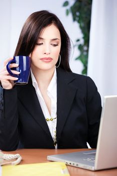 Portrait of a pretty business woman in office