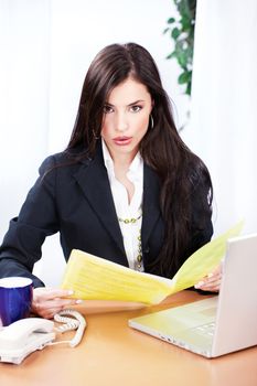 Surprised business woman reading files in office