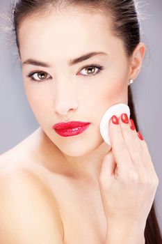 pretty woman applying makeup