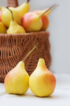 Some yellow pears in basket on table
