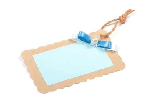 Blank tag tied with brown string. Price tag, gift tag, sale tag, address label, etc.