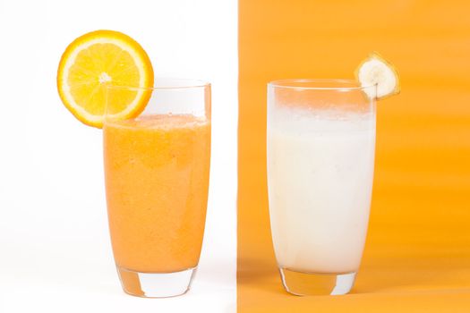 Orange and Banana vitamins isolated on a white and orange background.