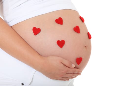 Pregnant woman with several red hearts on her baby bump. All on white background.