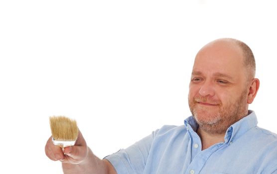 Attractive elderly man painting with brush. All isolated on white background. Extra copy space on the left.