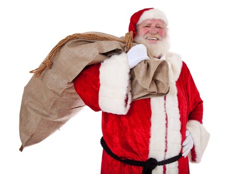 Santa Claus in authentic look carrying bag of presents. All on white background.