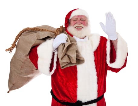 Santa Claus in authentic look carrying bag of presents. All on white background.