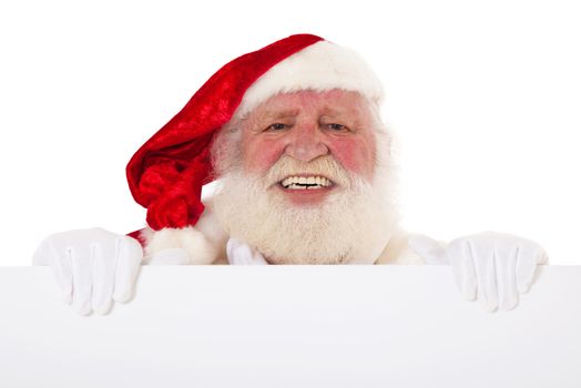 Santa Claus in authentic look behind white sign. All on white background.