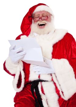 Santa Claus in authentic look having fun while reading the wish list. All on white background.