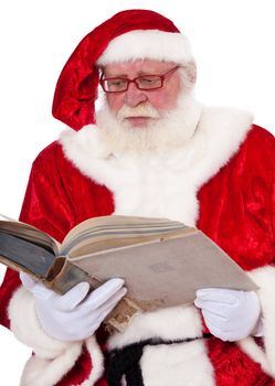 Santa Claus in authentic look reading in old book. All on white background.