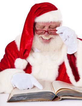 Santa Claus in authentic look reading in old book. All on white background.