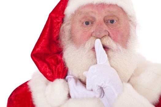 Santa Claus in authentic look wants you to keep a secret. All on white background.