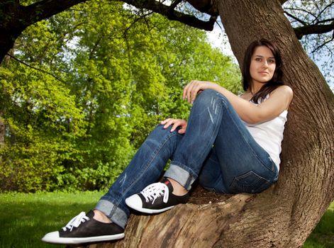 Attractive young woman enjoys nature outside.
