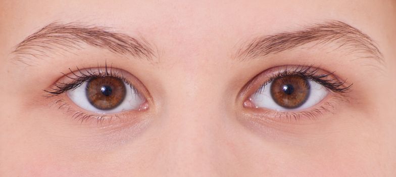 Eyes of an attractive teenage girl. All on white background.