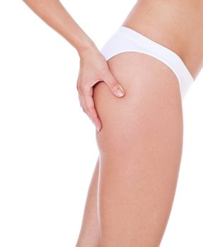 Attractive female person checking her skin on cellulite. All on white background.