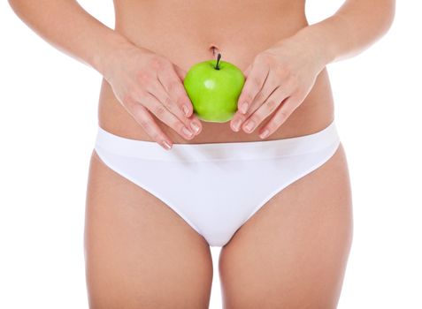 Attractive female person in white underwear holding green apple. All on white background.