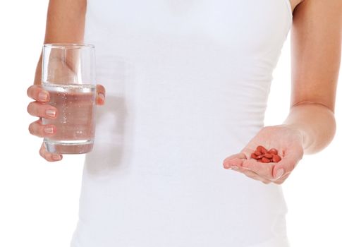 Female person holding glass of water and pile of pharmaceuticals. All on white background.
