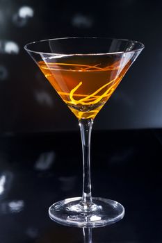 Manhattan cocktail over black and bright sparkles