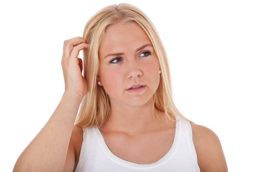 Attractive teenage girl deliberates a decision. All on white background.