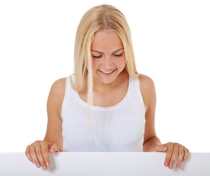 Attractive teenage girl standing behind blank white sign. All on white background.