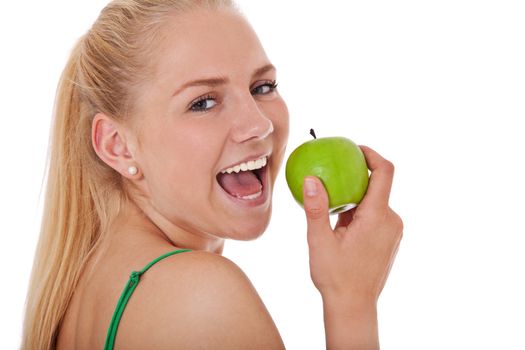Attractive teenage girl eating green apple. All on white background.