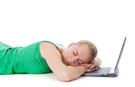 Attractive teenage girl sleeping next to her laptop. All on white background.