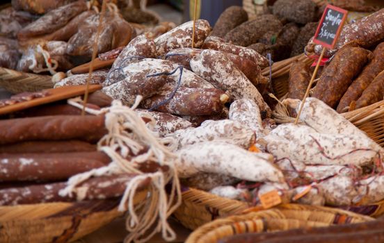 Fine air-dried sausages at market stall.