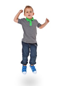 Full length shot of a cute little boy jumps. All isolated on white background.