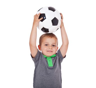 Cute little boy playing with a soccer ball. All isolated on white background.