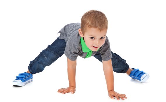 Full length shot of a cute little boy doing sports. All isolated on white background.