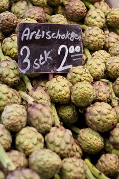 Fresh artichoke at market stall.