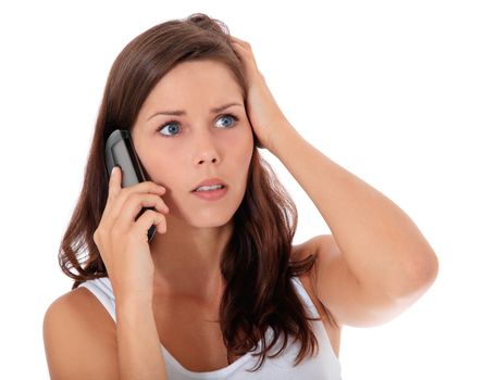 Attractive woman gets shocking news during phone call. All on white background.