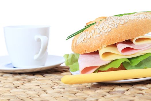 Fresh made roll with cheese and boiled ham. All on white background.