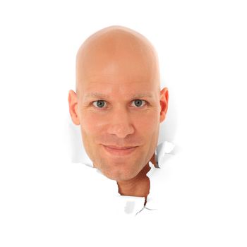 Attractive bald man breaks his head trough white paper wall. All on white background.