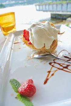 Strawberry and cream dessert over a decorated white plate