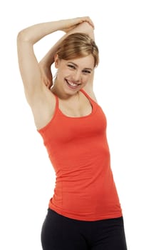 young happy fitness woman in red shirt stretching her arms on white background