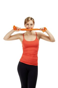 young fitness woman bites in orange fitness ribbon on white background