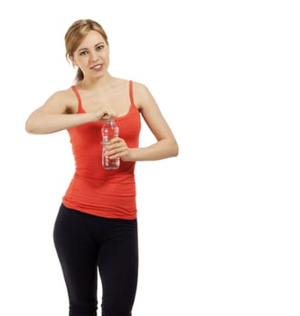 young smiling fitness woman opening a bottle with water on white background