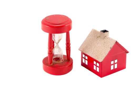 Red house imitation and broken sand glass clock isolated on white background. Real estate bubble collapse.