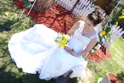 A bride holds her flower bouquet in her hands.