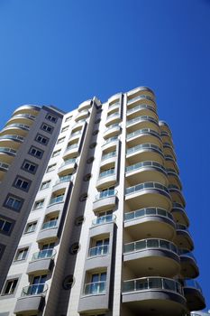 high modern residential building on a background blue sky