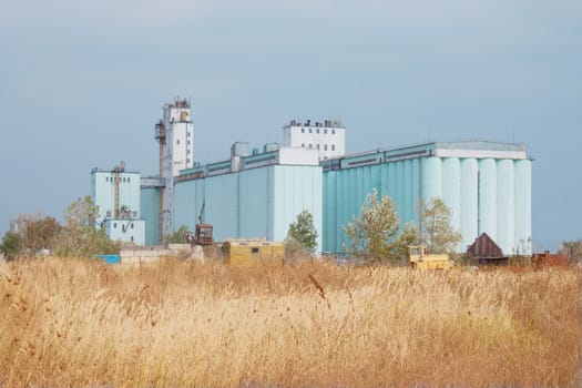 Large grain elevator rises among the steppe