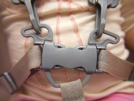 Closeup of a toddler wearing a belt, locked