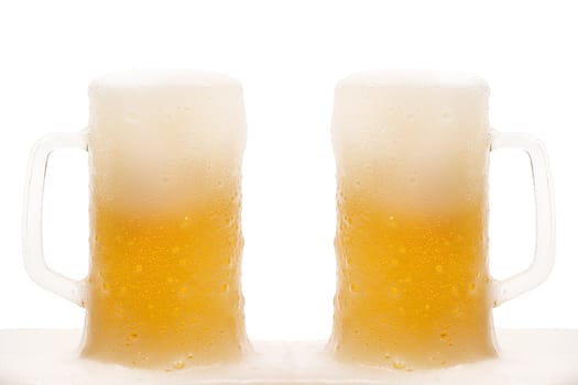 Two mug of beer with froth isolated on white background