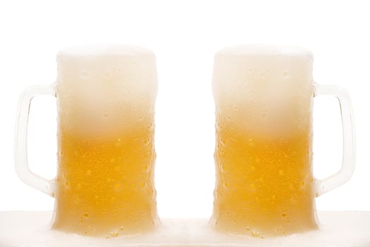 Two mug of beer with froth isolated on white background