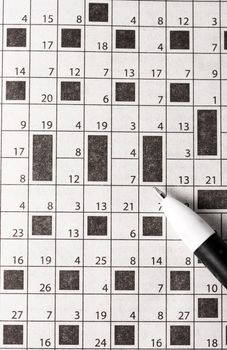 pen in paper, crossword puzzle white background