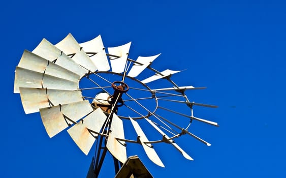 Rural Australian windmill against blue sky backdrop